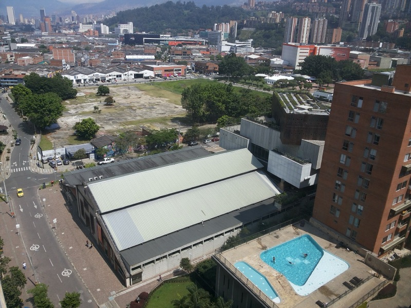 The MAMM's long industrial halls and the trees and lawns of Ciudad del Río seen from a nearby tower